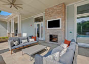 Thumbnail 7 of 21 - Living room decor at Ascent at Mallard Creek Apartment Homes, couches, table, fireplace, and a tv.