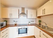 Thumbnail 7 of 7 - a kitchen with white cabinets and a sink