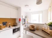 Thumbnail 2 of 8 - a kitchen with a counter top and a window
