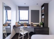 Thumbnail 3 of 8 - a bedroom with a desk and a window