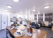 Thumbnail 4 of 8 - a kitchen and living room with a wooden table