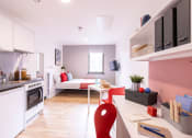 Thumbnail 3 of 8 - a kitchen and a living room with a table and a couch