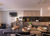 Thumbnail 5 of 8 - a kitchen and dining area in a 555 waverly unit
