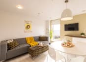 Thumbnail 5 of 8 - a living room with a couch and a table