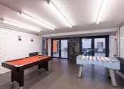 Thumbnail 6 of 8 - a games room with a pool table and foosball