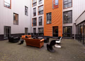 Thumbnail 8 of 8 - a courtyard with couches and chairs outside of a building
