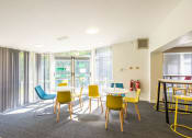 Thumbnail 2 of 8 - a seating area with tables and chairs