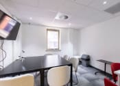 Thumbnail 8 of 8 - a conference room with a table and chairs and a television