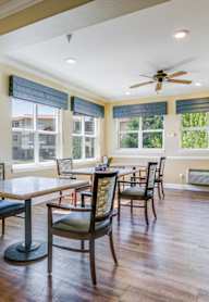 A dining room with a table and chairs.