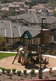 people sitting on benches in front of a tall building