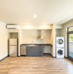 a kitchen with a washing machine and a refrigerator in a house