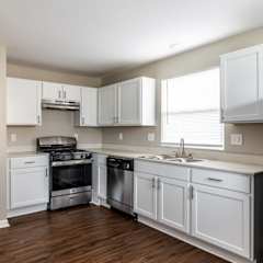 A kitchen with white cabinets and appliances.