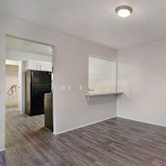 A room with a wooden floor and white walls.