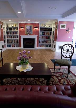 A living room with a red couch and a coffee table.