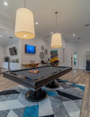 a pool table in the center of a living room