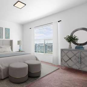 A bedroom with a large bed and a round mirror on the dresser.