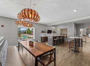 A modern kitchen with a wooden table and chairs.