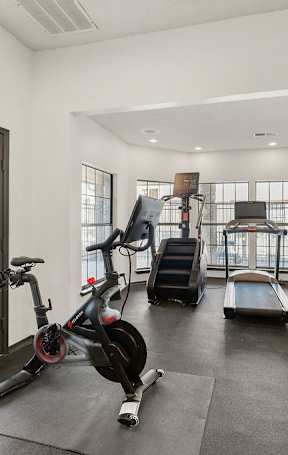 A spacious room with a ceiling fan and sliding glass doors.