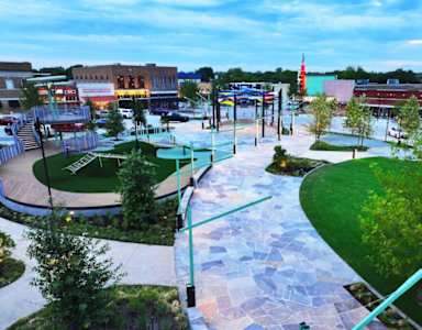 A park with a walkway and a green area.