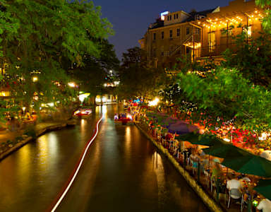A canal with a car driving down it.