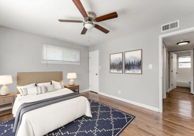 a bedroom with a bed and a ceiling fan