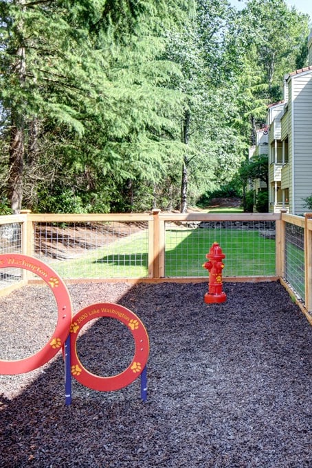 a fenced in play area with a red fire hydrant at 2000 Lake Washington Apartments, Renton, WA, 98056