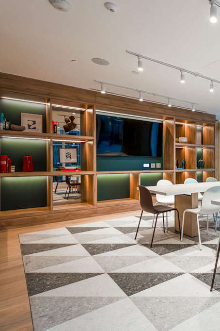 A conference room with a long table surrounded by chairs.
