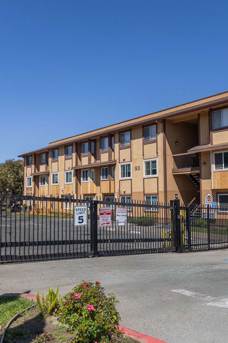 an apartment building with a fence and a gate