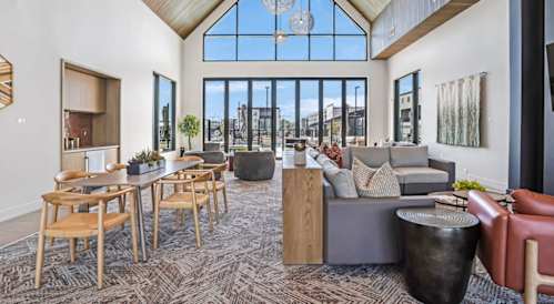 A large room with a lot of furniture and a big window.