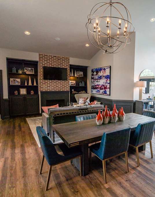 A dining room with a wooden table and chairs.