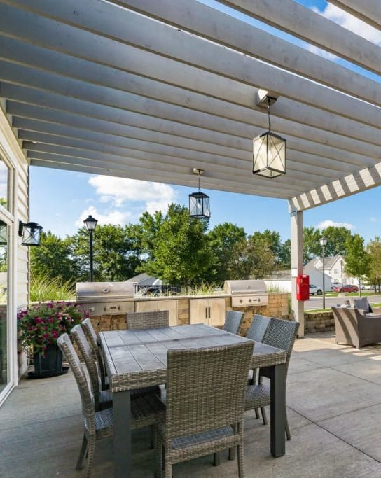an outdoor kitchen with stainless steel appliances and bar stools
