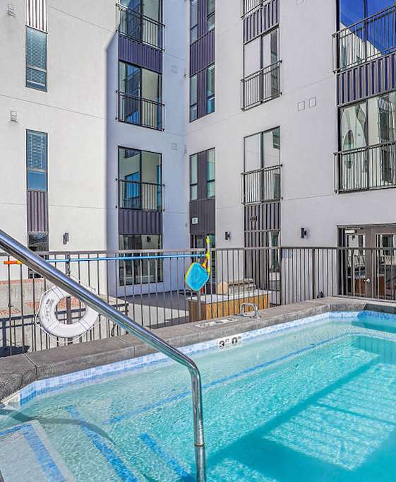 A pool with a sign that says "No Diving Allowed" in front of a building.
