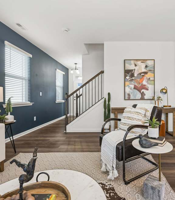 A living room with a white couch, a chair, and a coffee table.