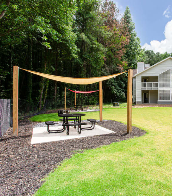 a yard with a picnic table and a house in the backgroundat The Hub at 934 Apartments, Georgia, 30349