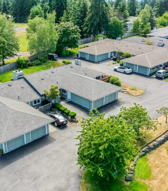 an aerial view of several houses in a parking lot