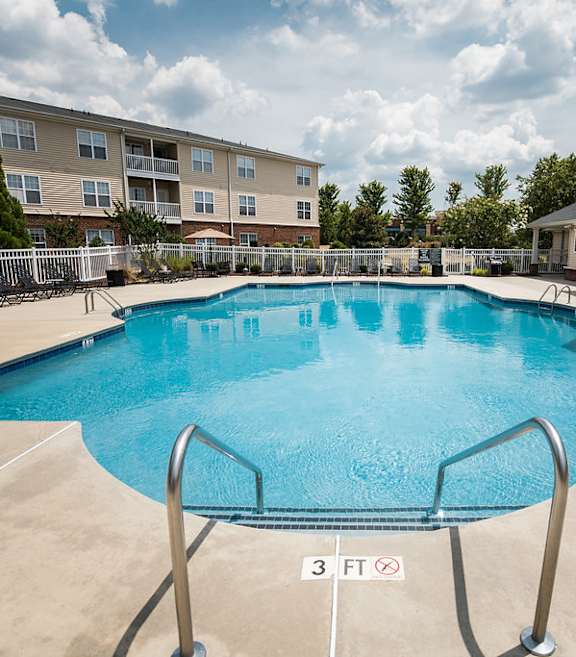 A large swimming pool with a 3 feet depth sign.