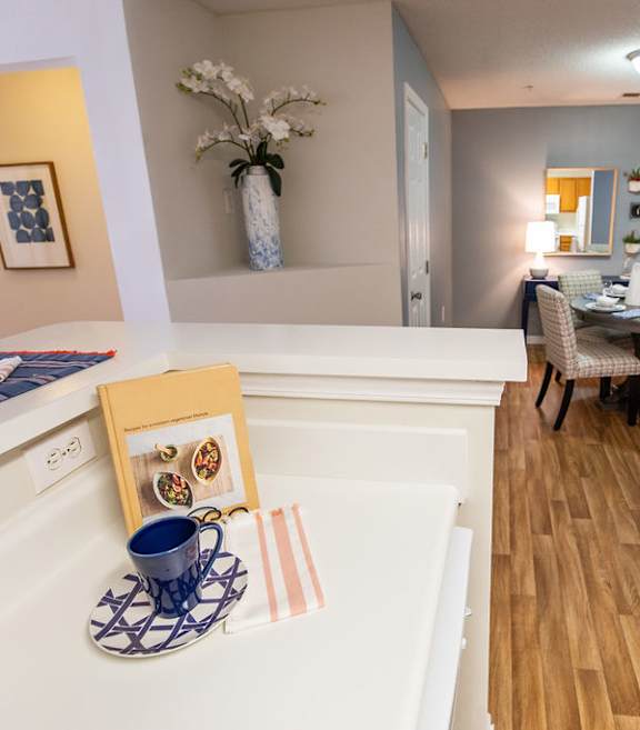 A dining room with a table set for two.