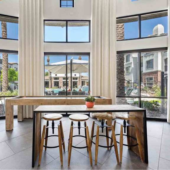 A modern dining area with a long table and chairs.
