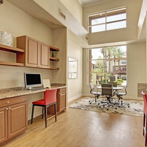The business center at Mozaic at Steele Park with desks and a desktop computer. 