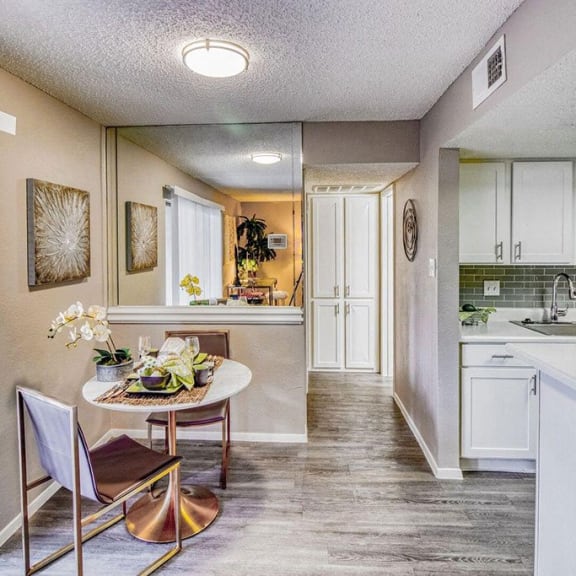 a kitchen and dining room with a table and chairs