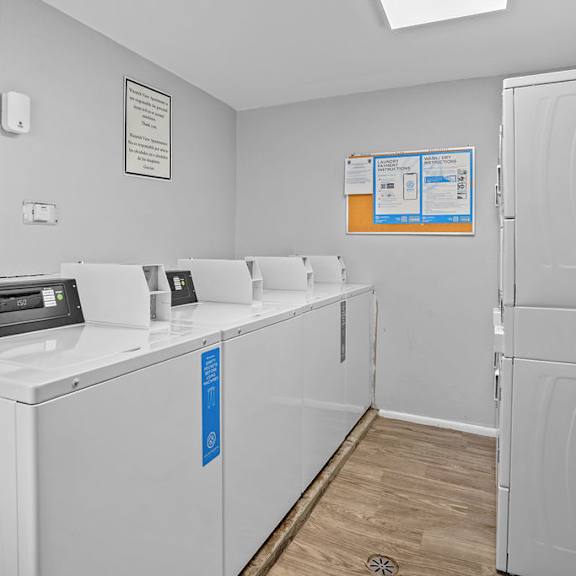 a laundry room with washing machines and a refrigerator