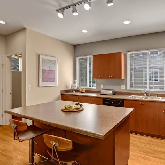 A kitchen with brown cabinets and a wooden island.