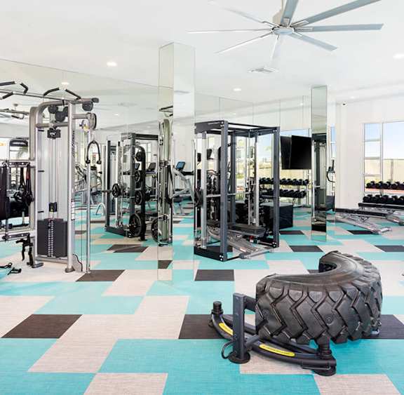 Fitness center at Rivue with a cable machine and squat rack at our Chula Vista apartments.