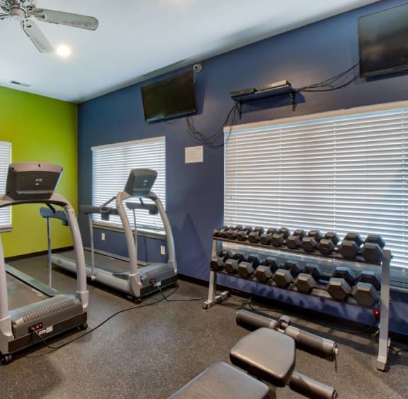 a gym with treadmills and other exercise equipment