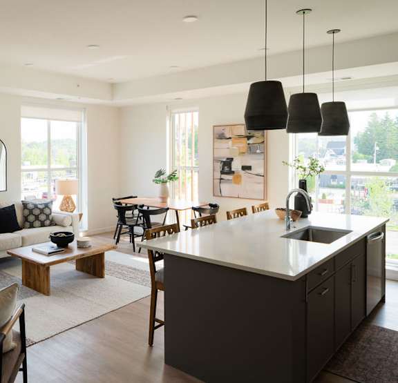 a living room with a couch and chairs and a table at One West Drive Apartments, Excelsior, Minnesota
