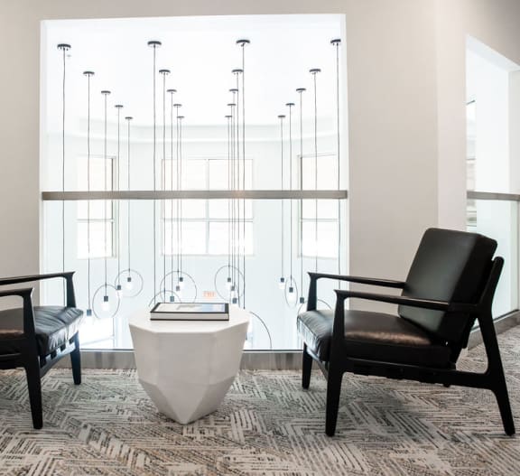 a courtyard with tables and chairs at night at 401 Oberlin, Raleigh, 27605