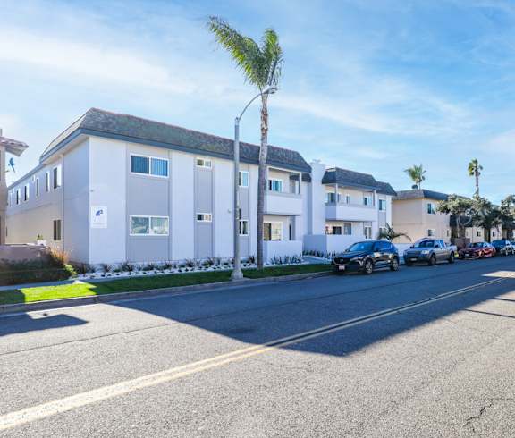 A modern kitchen with a dining area and a view of the balcony.