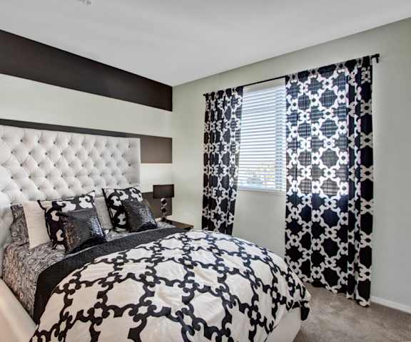 A fully furnished black and white bedroom at Artisan at Main Street Metro. 