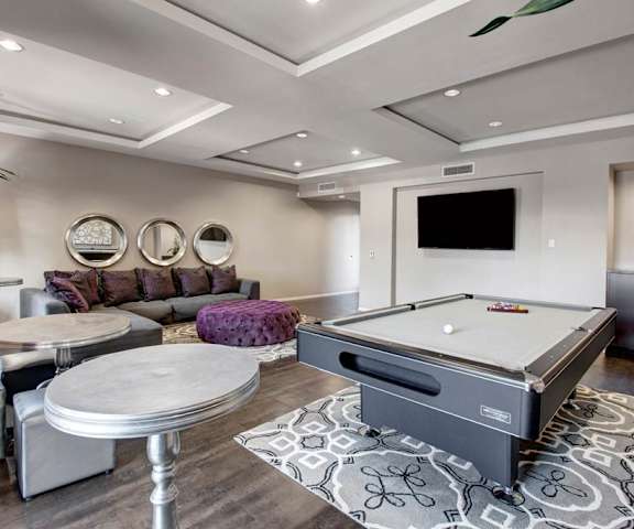 A games room with a pool table and couches at Artisan at Main Street Metro. 