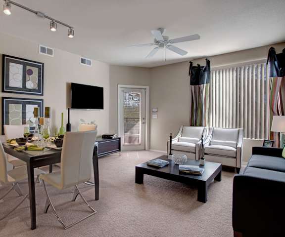 A living room and dining room with a table and chairs and couch at Aspire Pinnacle Peak. 